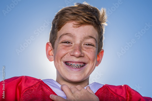 Принти на полотні Freckled young football player with braces smiling outside