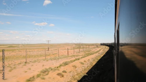 Mongolia Trans Siberian train ride through desert view from window, wagon on Mongolian railway travel vacation in Asia 4k