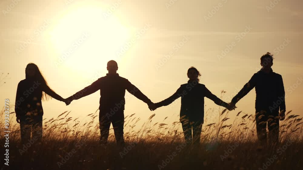 teamwork. team community hold hands together silhouette at sunset unity. group of people hands. teamwork a workers carry out one mission go the goal business. team in the company working partnership