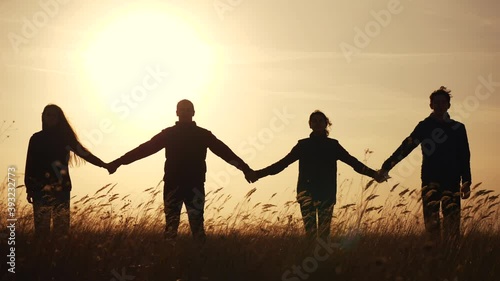 teamwork. team community hold hands together silhouette at sunset unity. group of people hands. teamwork a workers carry out one mission go the goal business. team in the company working partnership