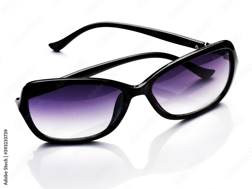 Women's elegant sunglasses with black frames. Sunglasses with purple lens isolated on white background. Women's elegant sunglasses with black frames. Sunglasses with purple lens isolated on white background.