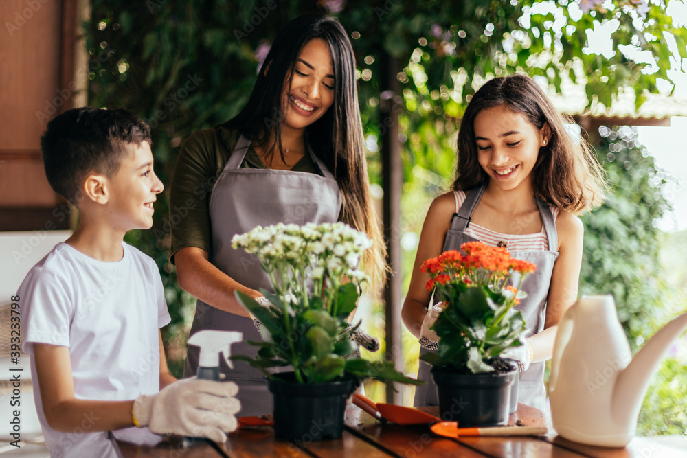 © kleberpicui - Latin family taking care of the plants at home. © kleberpicui - Latin family taking care of the plants at home.