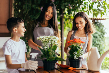 Latin family taking care of the plants at home.