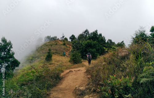 A woman going back from top of mount Prau Wonosobo Indonesia