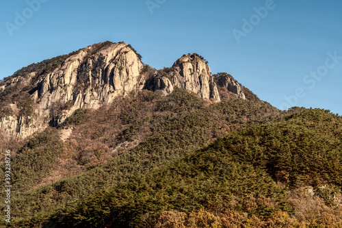 Mountain peak of granite against blue sky.