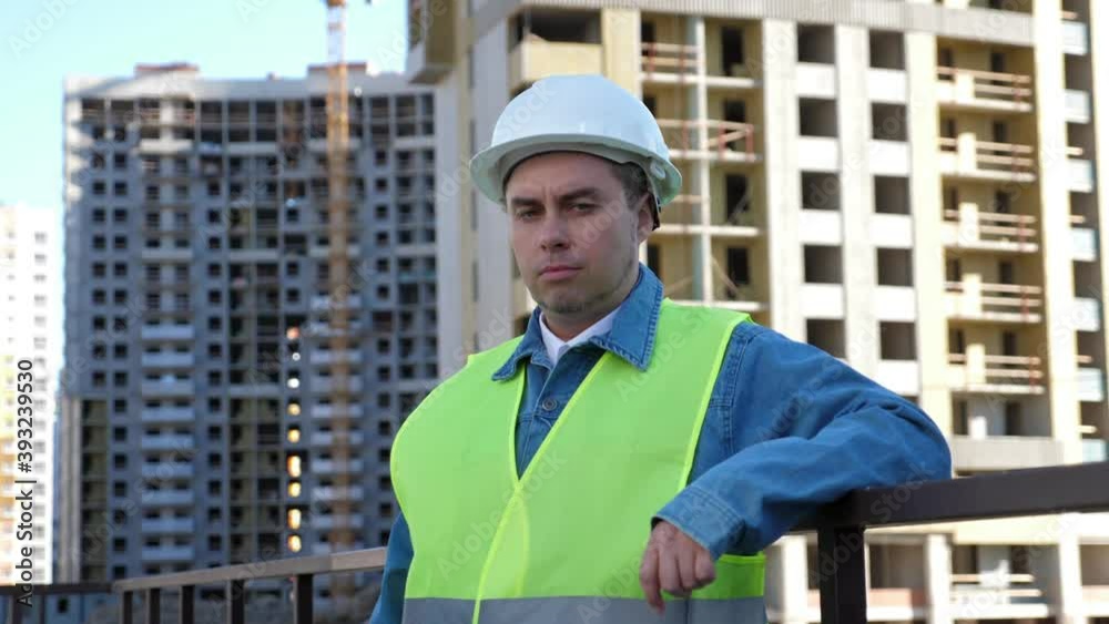 Worker staff or engineer in white protective helmet at construction site. Outdoors Worker staff or engineer in white protective helmet at construction site. Outdoors