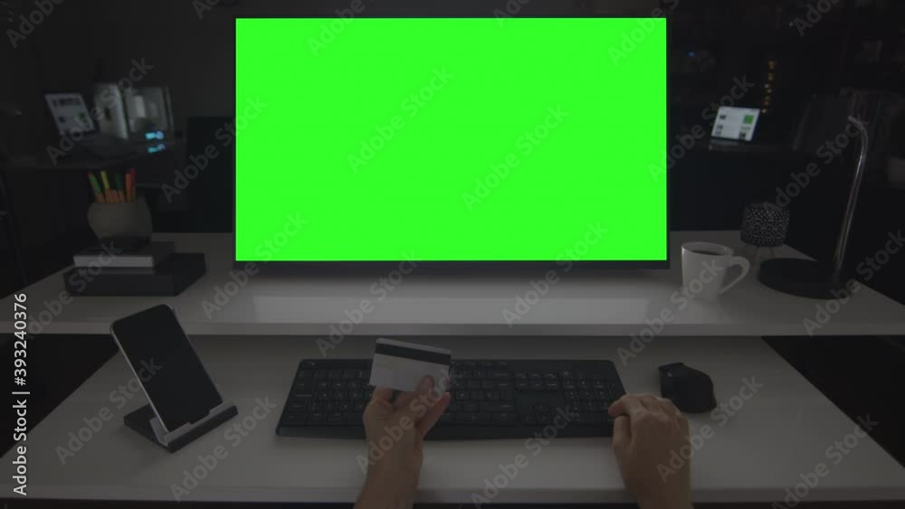 Online shopping. Hands typing information on a keyboard. Credit card. Desktop computer with chroma key. Perfect to put your own images or videos. Track corners with perspective corner pin. Online shopping. Hands typing information on a keyboard. Credit card. Desktop computer with chroma key. Perfect to put your own images or videos. Track corners with perspective corner pin.