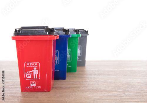 Four different color garbage bins