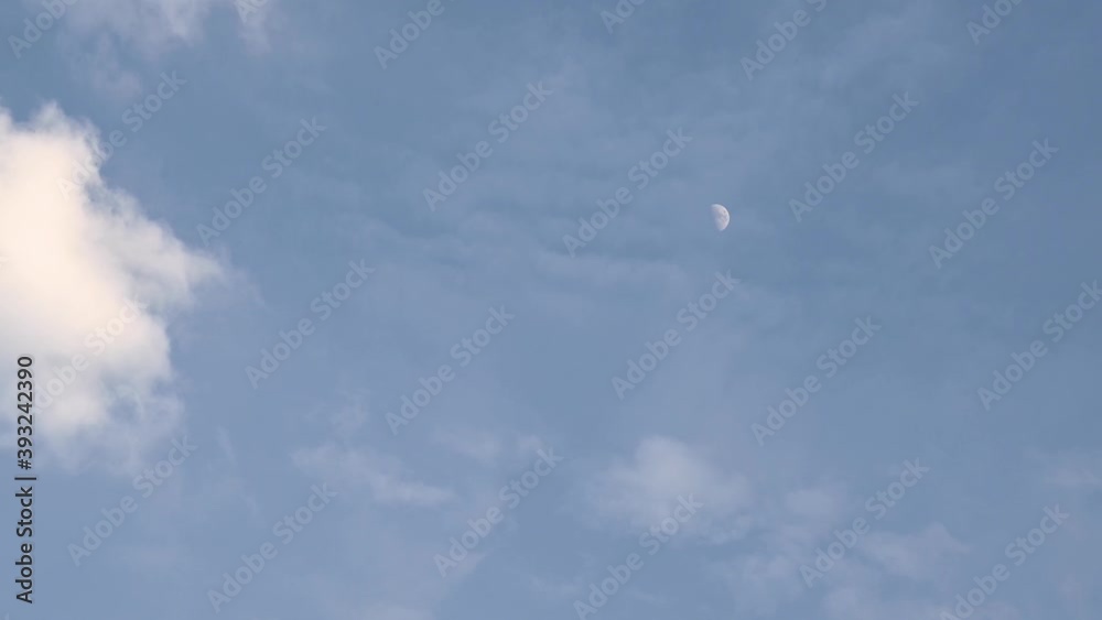 Moon in its first quarter time lapse as seen before dark with clouds almost covering it on the right side of the frame. Moon in its first quarter time lapse as seen before dark with clouds almost covering it on the right side of the frame.