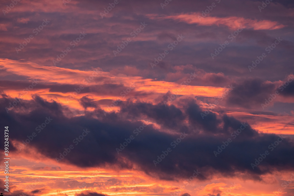 beautiful cloudy sky with pink, red orange and purple colour right after sunset