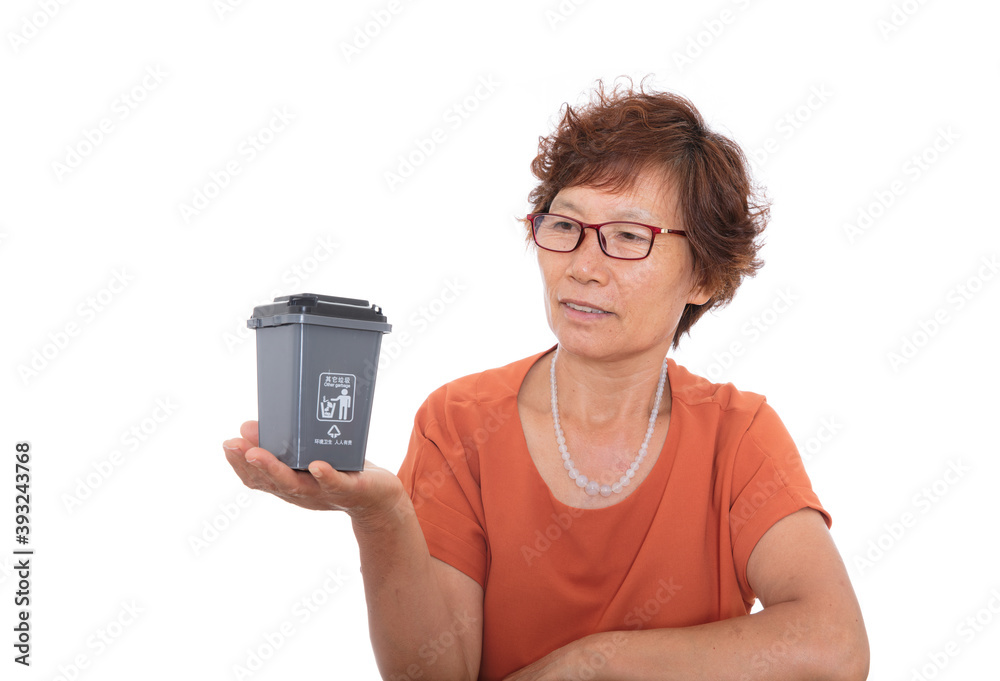 Chinese woman holding grey other trash trash bin in front of white background Chinese woman holding grey other trash trash bin in front of white background