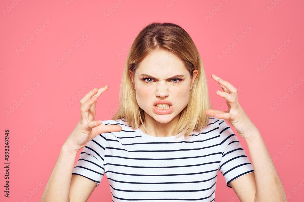 Blonde striped t-shirt emotion gesture hands displeased facial expression pink background Blonde striped t-shirt emotion gesture hands displeased facial expression pink background