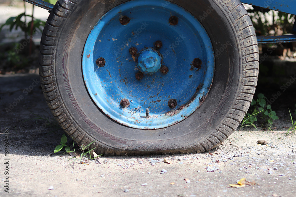 Flat tire wheel of a car on the floor cement outdoor,portrait.