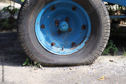 Flat tire wheel of a car on the floor cement outdoor,portrait. © Monta