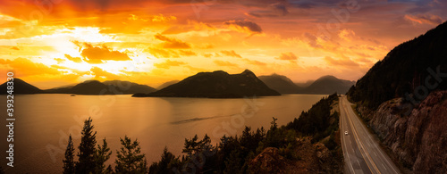 Sea to Sky Hwy in Howe Sound near Horseshoe Bay, West Vancouver, British Columbia, Canada. Aerial panoramic view. Dramatic Colorful Sunset Sky with Sunrays