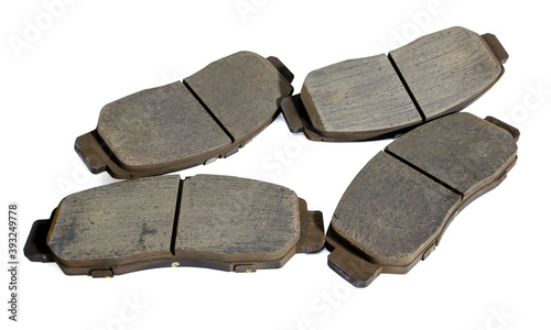 Old car front brake pads on white background