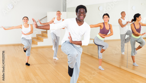 Adult people learning swing steps at dance class and smiling © JackF