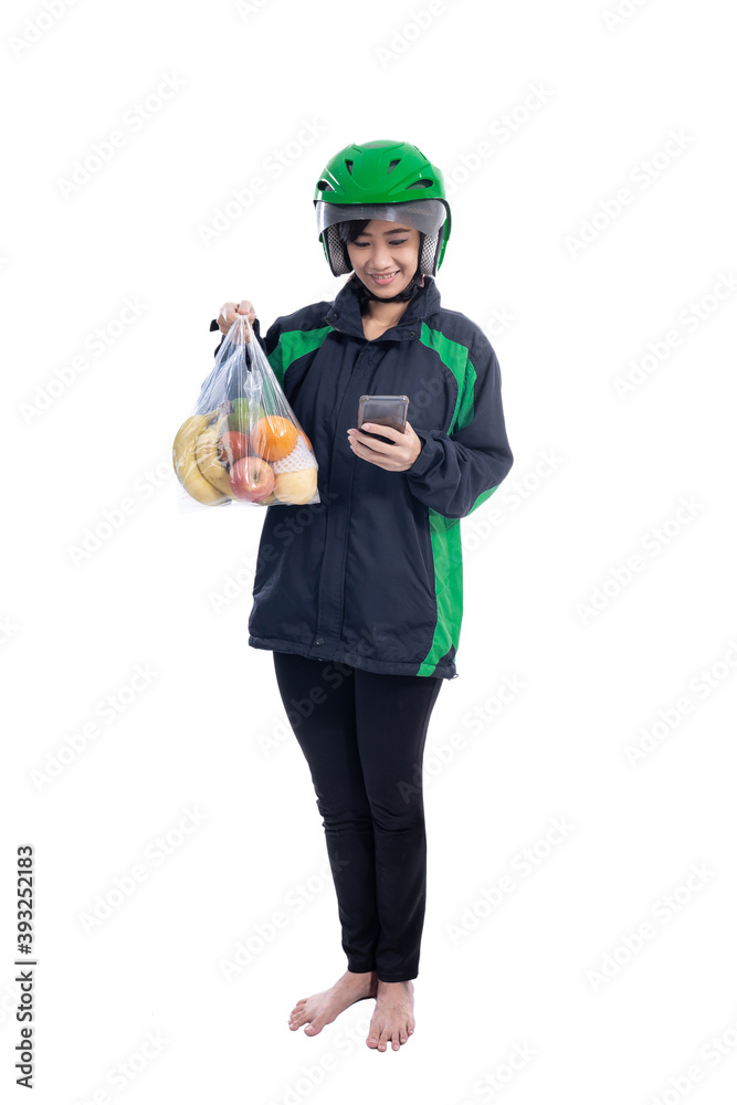 female uber delivery courier wearing helmet bring groceries in the bag female uber delivery courier wearing helmet bring groceries in the bag