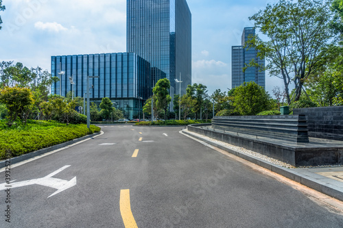 clean asphalt road through office block area, suzhou, china