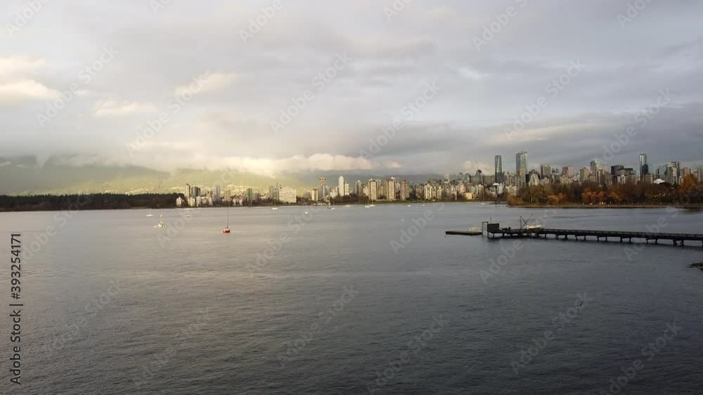 Aerial view of autumn Vancouver downtown and small red yacht in the sea Aerial view of autumn Vancouver downtown and small red yacht in the sea