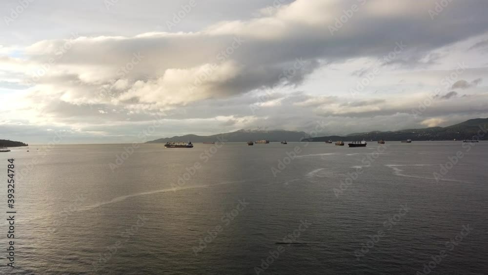 Aerial view of cargo ships waiting near Vancouver port on a sunny evening