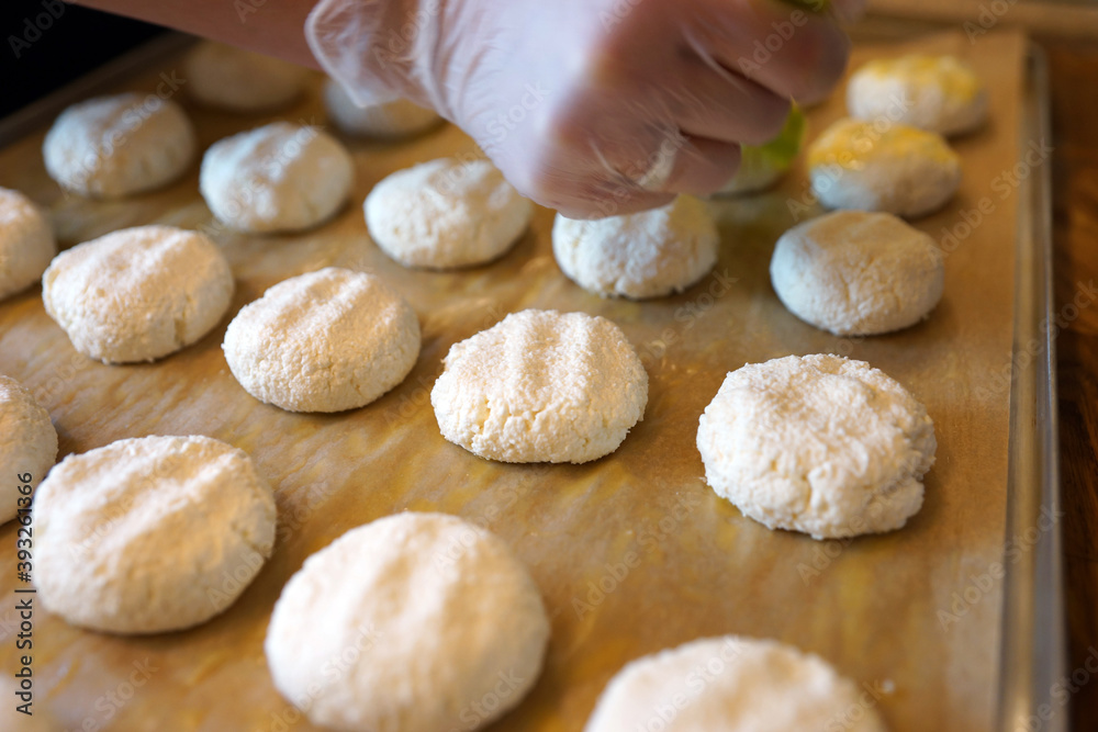The process of making cheese cakes. Cheesecakes on a baking sheet before baking.
