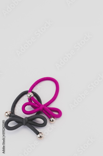 Vertical shot of colored hair bands with silver beads on a white background with space for your text photo