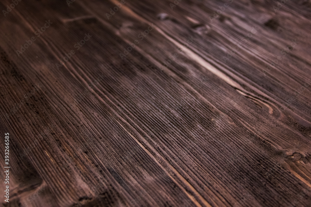 Fototapeta premium Dark brown wood wood texture background. Roughly processed wood. Close up surface