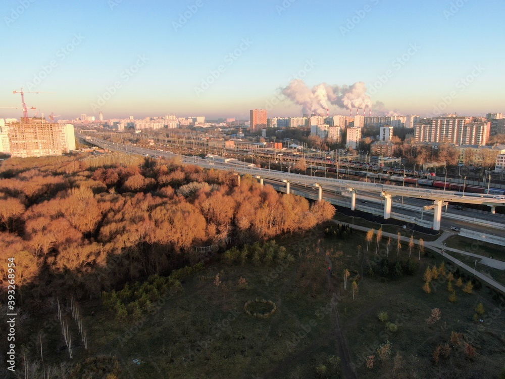 Aerial view panorama of multi-level transport interchange in the center of the big city at dawn. Beautiful panoramic landscape infrastructure of modern city from great height