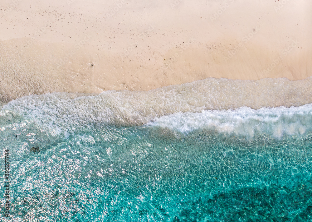 Aerial view of clear sea waves and white sandy beaches in summer.