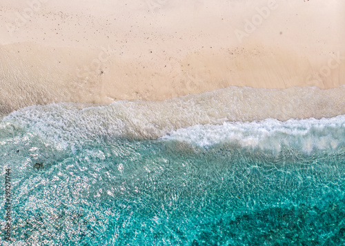 Aerial view of clear sea waves and white sandy beaches in summer.