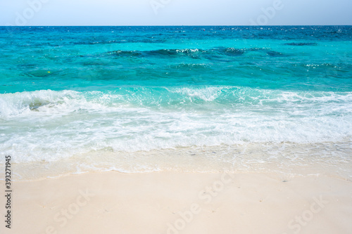 Fototapeta Naklejka Na Ścianę i Meble -  Clear sea waves and white sandy beach in summer.