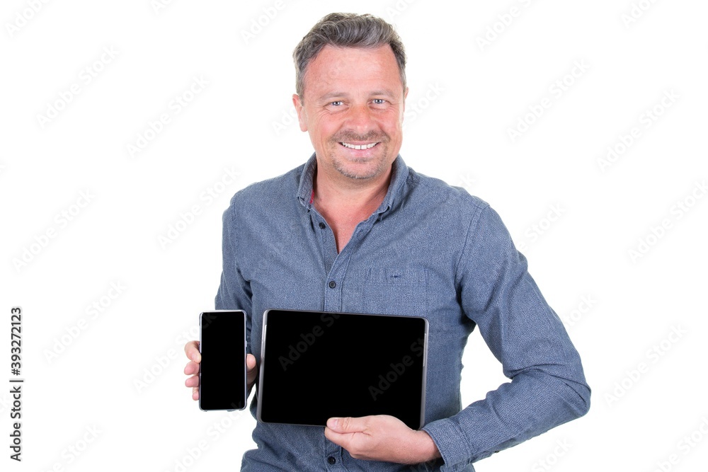 Happy handsome man in formal wear with smile holds digital tablet computer and smartphone and show blank screen copyspace Happy handsome man in formal wear with smile holds digital tablet computer and smartphone and show blank screen copyspace