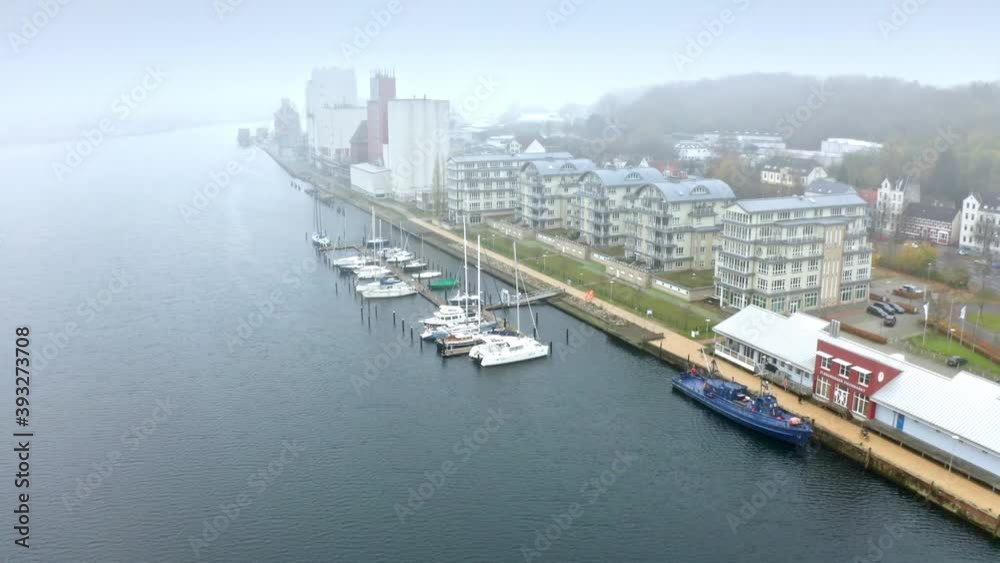 Drone flight over foggy Flensburg port and the small town overview, Germany Drone flight over foggy Flensburg port and the small town overview, Germany