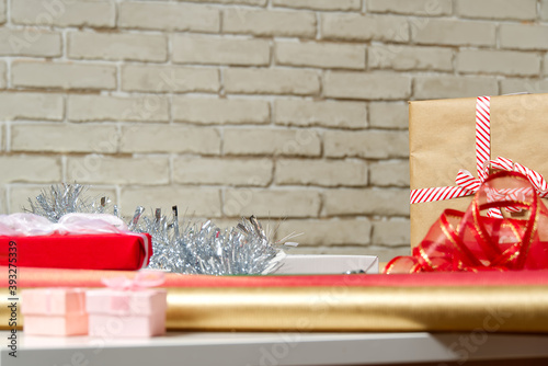 Fototapeta Naklejka Na Ścianę i Meble -  DIY Gift Wrapping station. Beautiful christmas gifts Christmas wrapping station concept side view with copy space