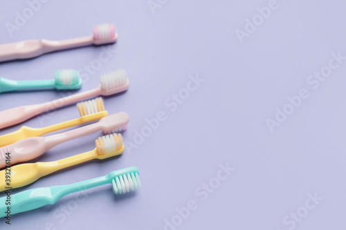 Toothbrushes on color background