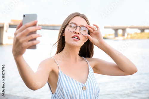 Beautiful young woman takin...