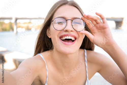 Beautiful young woman takin...