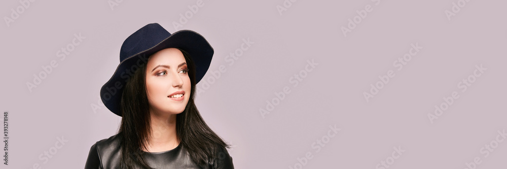 Pretty young woman at black hat. Looking side. High quality photo. Elegant female portrait. Beauty makeup. Grey background. Copyspace. Gorgeous romantic face. Perfume concept. Pretty young woman at black hat. Looking side. High quality photo. Elegant female portrait. Beauty makeup. Grey background. Copyspace. Gorgeous romantic face. Perfume concept.