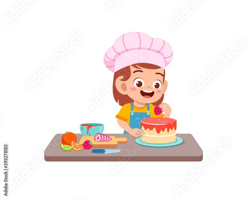 happy cute little kid boy and girl wear chef uniform and cooking a birthday cake