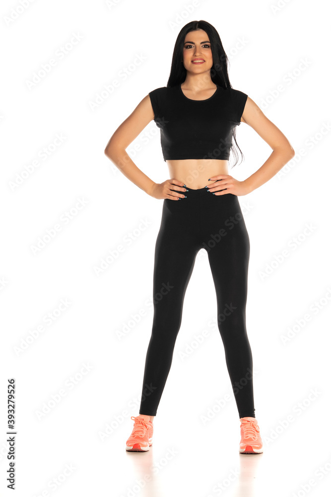 Fototapeta premium beautiful young sporty woman standing on white