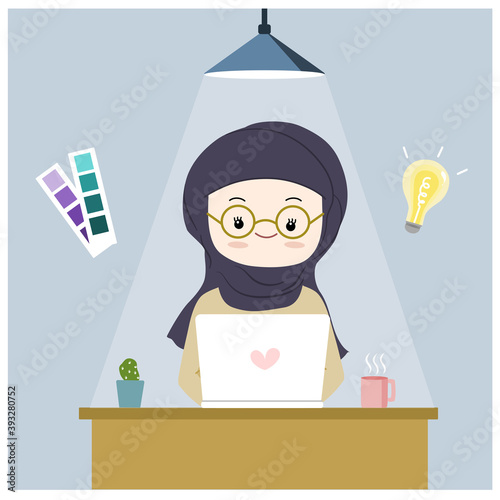 Muslim girl working with laptop on the desk
