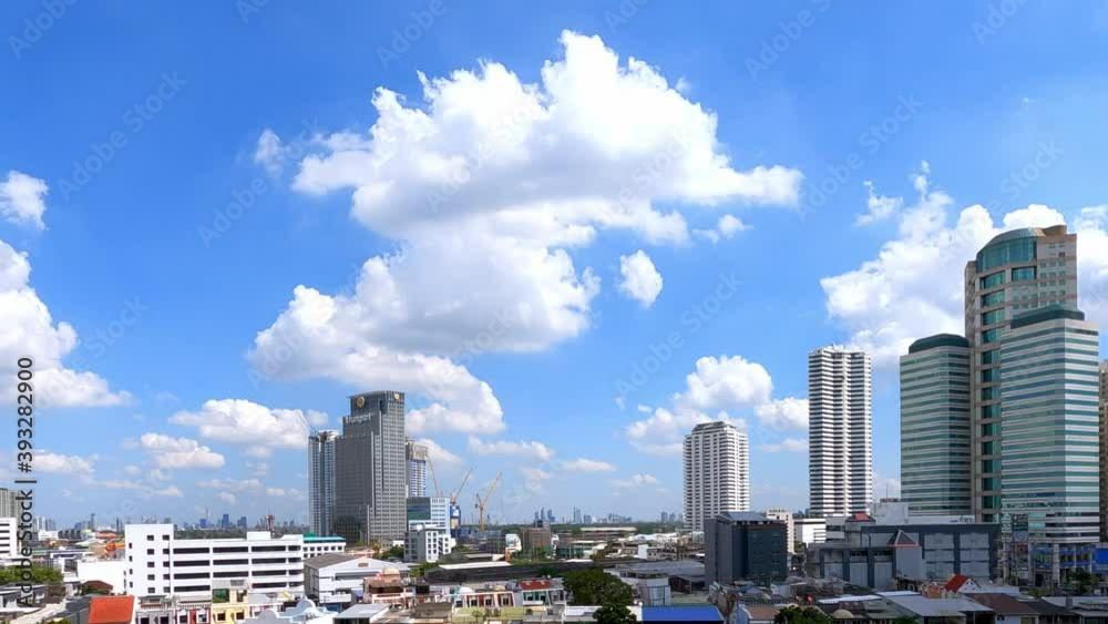 Time lapse of modern district cityscape with cloud pass over buildings and skyscrapers. Bangkok, Thailand