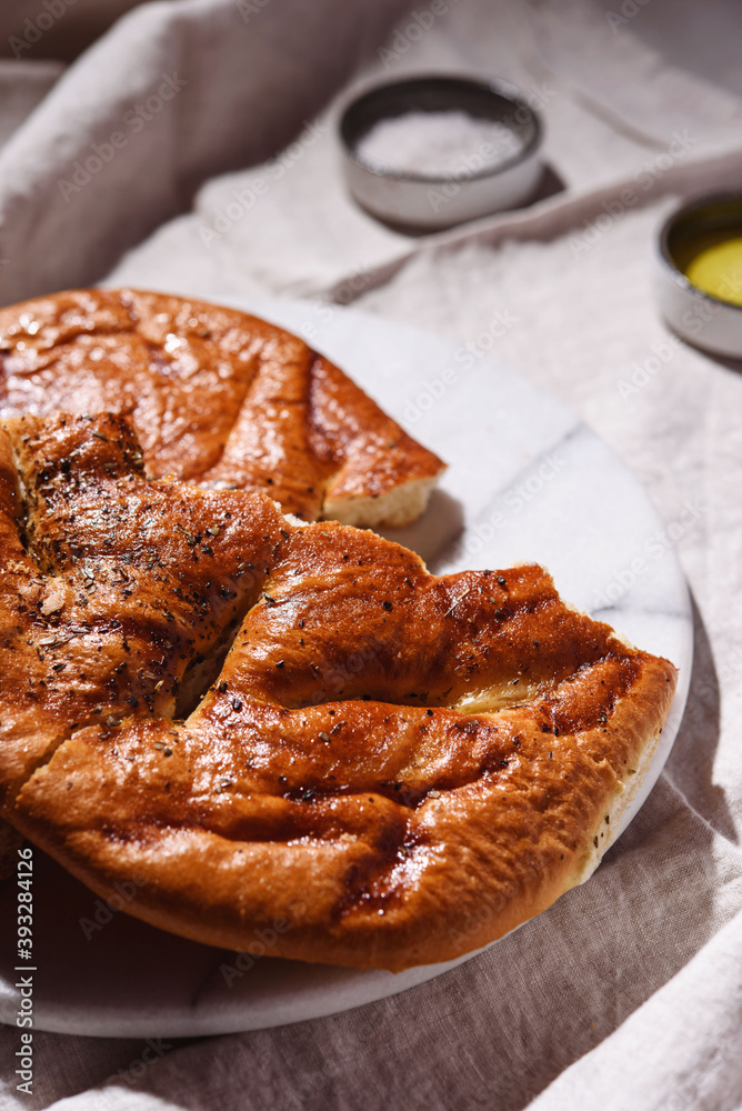 Homemade fresh baked Fougasse (French Bread) with thyme and olive oil on white background. Traditional Provencal dishes. Selective focus Homemade fresh baked Fougasse (French Bread) with thyme and olive oil on white background. Traditional Provencal dishes. Selective focus