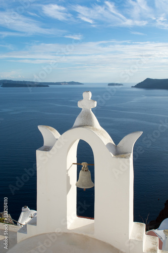 Church's white bell tower in Oia village, Santorini island