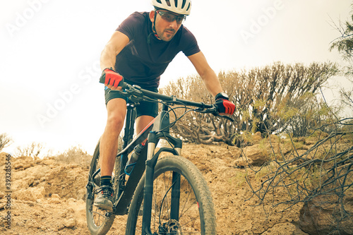 Cyclist in violet Riding the Mountain Bike on the spring Enduro Trail. Extreme Sport and Enduro Biking Concept.