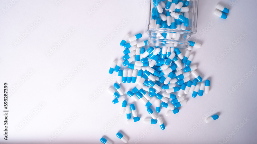 white and blue pills on white background