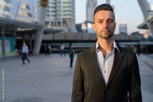 Portrait of handsome young businessman outdoors in city © Ranta Images