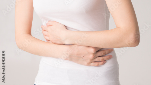 Wallpaper Mural young beautiful woman holding her belly. abdominal pain Torontodigital.ca