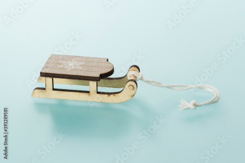 Vintage wooden sled with rope on bluish